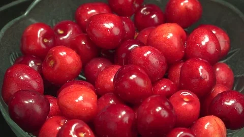 Fresh cherries rotating slow motion in plate Stock Footage 76466845