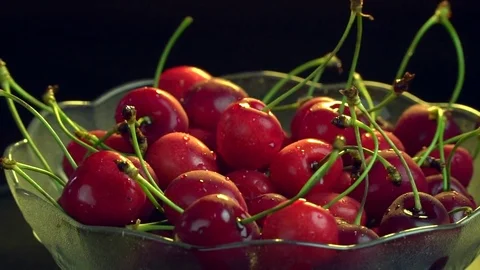 Fresh cherries rotating slow motion in plate Stock Footage 76466911