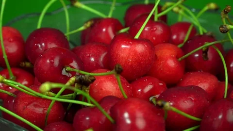Fresh cherries rotating slow motion in plate Stock Footage 76467084