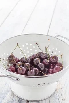 Fresh cherries in a sieve Stock Photos