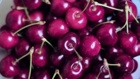 Fresh cherries spin on the plate. Top view Stock Footage 77211717
