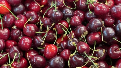 Fresh cherries with stems in closeup forming vivid natural background Stock Footage 340826502