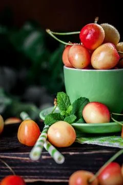 Fresh cherry in a Cup on a dark rustic wooden table. Background with space for Foto stock