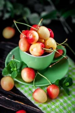 Fresh cherry in a Cup on a dark rustic wooden table. Background with space for Stock Photos