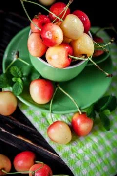 Fresh cherry in a Cup on a dark rustic wooden table. Background with space for Stock Photos