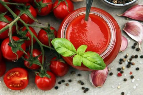 Fresh cherry tomato sauce on rustic background with cherry tomatoes Stock Photos