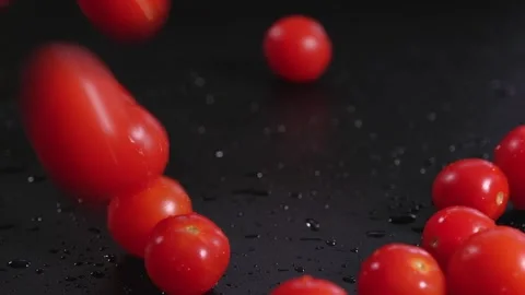 Fresh cherry tomatoes close-up on a black background. Organic products Stock Footage 257459875