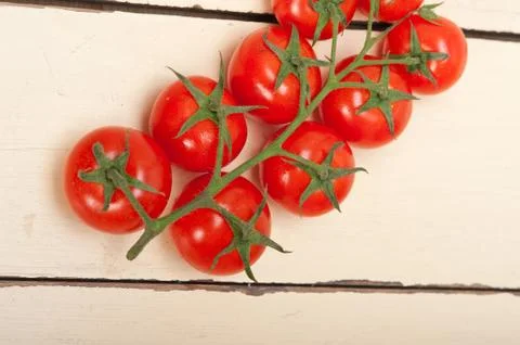 Fresh cherry tomatoes on a cluster Stock Photos