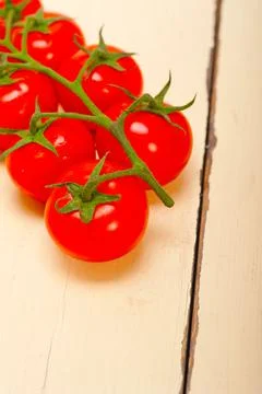 Fresh cherry tomatoes on a cluster Stock Photos