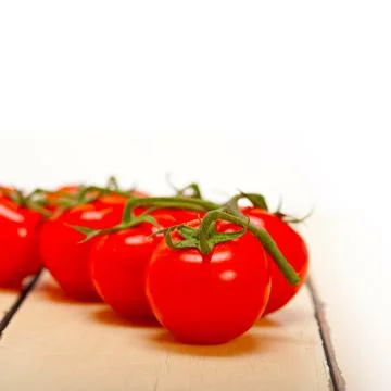 Fresh cherry tomatoes on a cluster Stock Photos