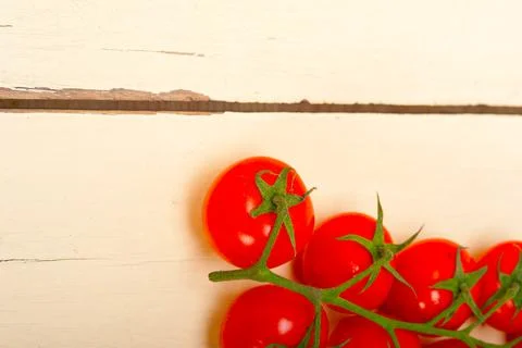 Fresh cherry tomatoes on a cluster Stock Photos
