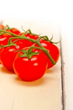 Fresh cherry tomatoes on a cluster Stock Photos