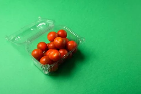 Fresh cherry tomatoes in disposable plastic package Stock Photos