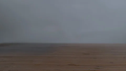 Fresh cherry tomatoes falling and bouncing on wooden surface Stock Footage 100006023