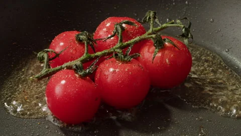 Fresh cherry tomatoes in a frying pan with olive oil and spices. Cooking tomato Stock Footage 254116720