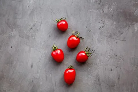 Fresh cherry tomatoes on a gray concrete background, top view, flat lay, mock Foto stock
