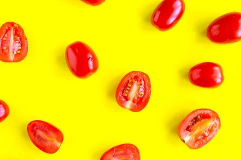 Fresh cherry tomatoes pattern on bright yellow background, minimal concept Stock Photos