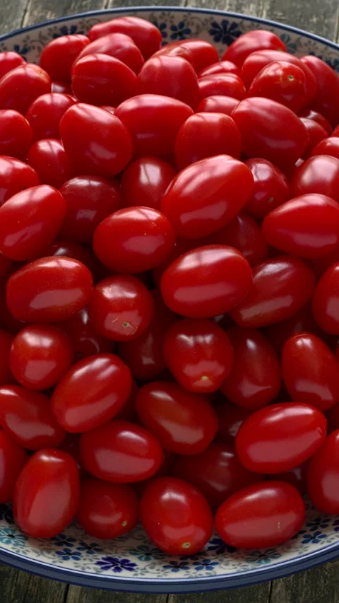 Fresh cherry tomatoes on a plate. Vertical video. Stock Footage 300950723