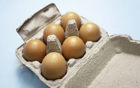 Fresh Chicken brown eggs on table Stock Photos