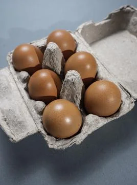 Fresh Chicken brown eggs on table Stock Photos