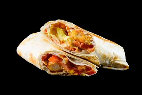 Fresh chicken caesar wrap cut in half with crispy nugget tomato and lettuce.. Stock Photos