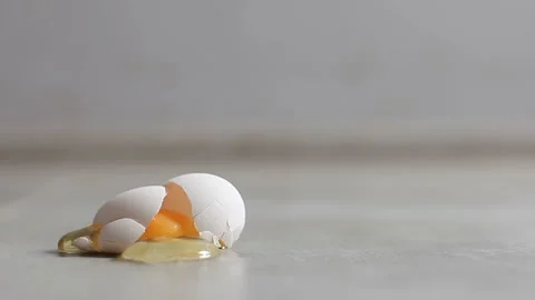 A fresh chicken egg is broken on the flo... | Stock Video | Pond5