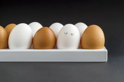 Fresh chicken egg in container on black paper background. Concept for Easter  Stock Photos