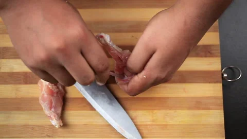 Fresh chicken wings cut by chef with a knife to bring a shape of lollipop Stock Footage 153649261