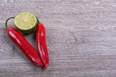 Fresh chilli and lime on a table Stock Photos