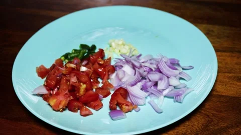 Fresh chopped raw vegetable onion tomato chilli and garlic in ceramic plat .. Vídeos de archivo 314416030