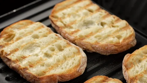 Fresh ciabatta bread on grill, slider shot. Ciabatta bread holes Stock Footage 242588310