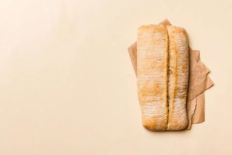 Fresh ciabatta bread on napkin on rustic background, Italian bread top view Stock Photos