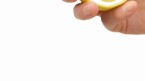 Fresh citrus juice dropping down from squeezed lemon. Close-up of male hand Stock Footage 125948990