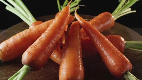 Fresh clean carrots close-up on a dark background Stock Footage 131968929