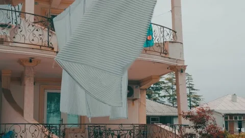 Fresh clean dries after being washed on the clothesline on the balcony of  Stock Footage 196925590