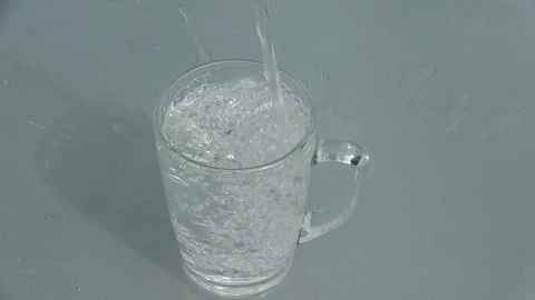 Fresh clean drinking water is poured into a mug. Stock Footage 94253308