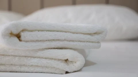 Fresh Clean Towels on Hotel Bed Stock Footage 339701219