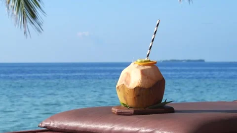 Fresh Coconut Drink With a Straw Served On A Tropical Island Beach, Maldives 動画素材 296336735