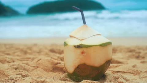 Fresh coconut with drinking straw on the beach, travel and holidays concept. Vídeo Stock 201087770