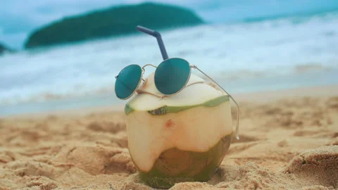 Fresh coconut with drinking straw on the beach, travel and holidays concept. Stock Footage 201087858