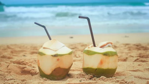Fresh coconut with drinking straw on the beach, travel and holidays concept. 库存影片 201087863