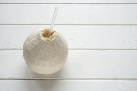 Fresh coconut with drinking straw Stock Photos