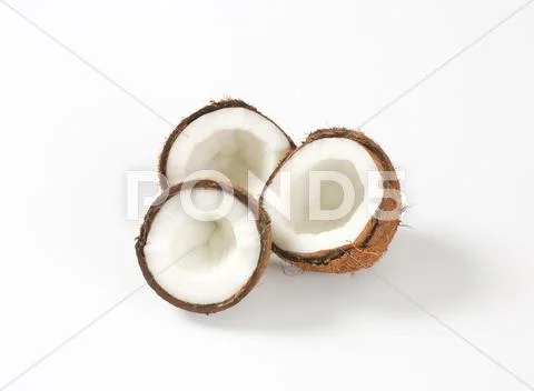 Fresh coconut halves Stock Photos