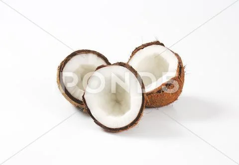 Fresh coconut halves Stock Photos