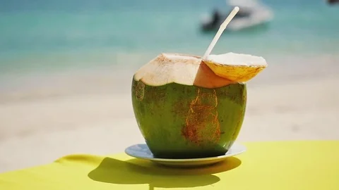 Fresh coconut on the table at the beach cafe. Slow motion. 1920x1080 Stock Footage 82121492
