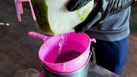 Fresh Coconut Water Pouring Through Strainer at Tropical Street Food Market Stock Footage 337227408