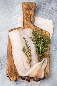Fresh cod fish fillet, showcasing its delicate texture and pristine color, .. Stock Photos