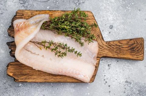 Fresh cod fish fillet, showcasing its delicate texture and pristine color, .. Stock Photos