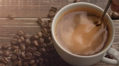 Fresh coffee and coffee beans on wooden table Stock Footage 62953070