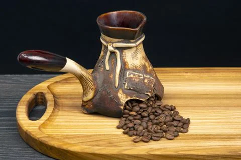Fresh coffee beans fall out of broken ceramic coffee Stock Photos